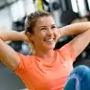 A woman smiling while doing crunches